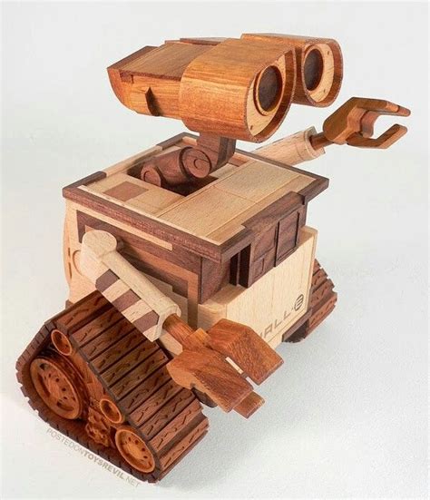 a wooden toy that looks like a robot with two large binoculars on it's head