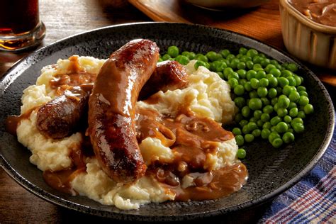 Irish O’ Garlic-style bangers or sausages and mashed potatoes are served with a Guinness-onion ...