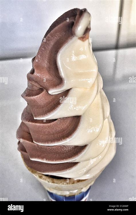 Chocolate vanilla swirl ice cream cone Stock Photo - Alamy