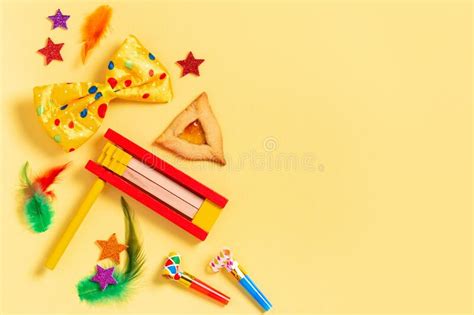 Purim Carnival Frame with Traditional Cookies, Costume Accessories and Decor on Bright Yellow ...