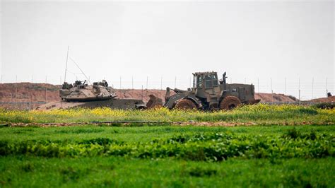 Gaza-Israel border: bulldozer lifts militant's body | World News | Sky News