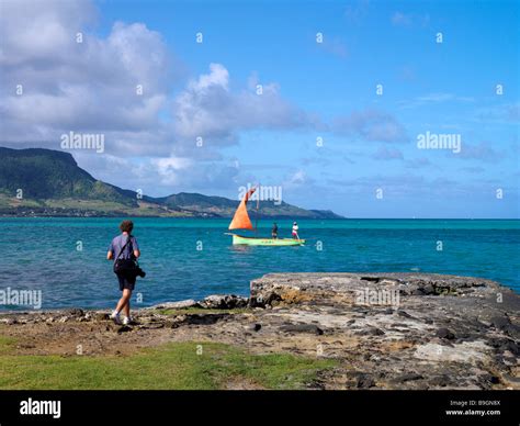 Mahebourg Mauritius Local Sailing Dingey Orange Sail and Photographer Stock Photo - Alamy