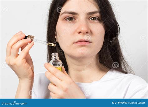 Woman Holding Natural Ecological Oil for the Face in a Glass Bottle with a Pipette. Cosmetology ...