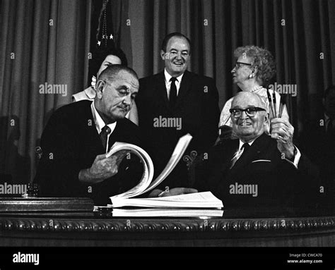 LBJ's Great Society programs. President Lyndon Johnson signing the Medicare Bill with former ...