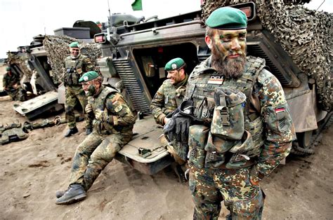 German armed forces, the Bundeswehr, stand next to their Marder light tanks during the NATO ...