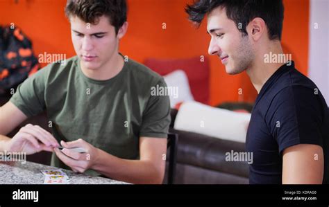 Cheerful friends playing cards Stock Photo - Alamy