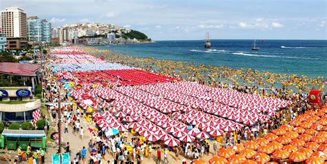 Horrendous! Haeundae Beach, Busan, South Korea. The red umbrellas proudly sponsored by famous ...