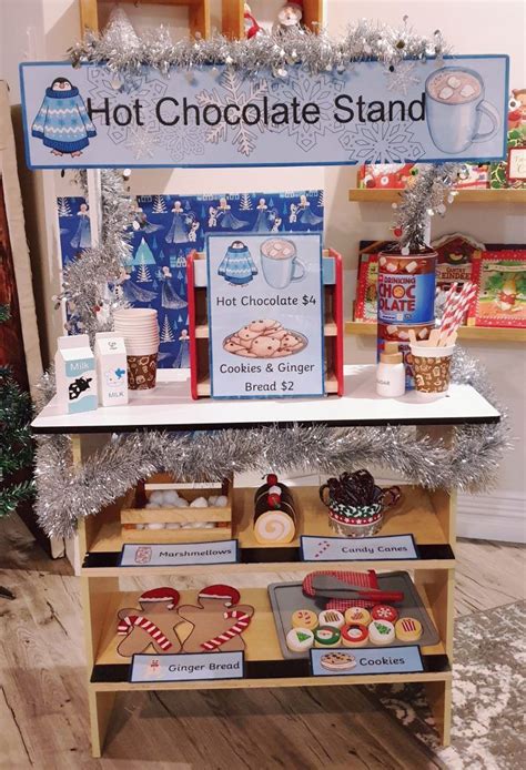 a hot chocolate stand with cookies and gingerbreads on it's display shelf