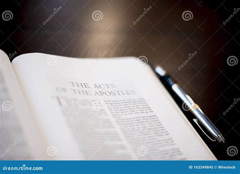 Closeup Shot of a Pen Bible Near a Fountain Pen on a Wooden Surface ...