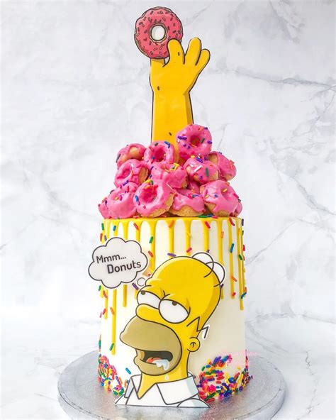 the simpsons donut cake is decorated with sprinkles and pink frosting