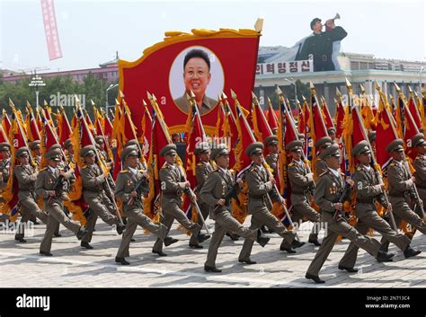 Military soldiers carry flags through the Kim Il Sung Square, Saturday ...