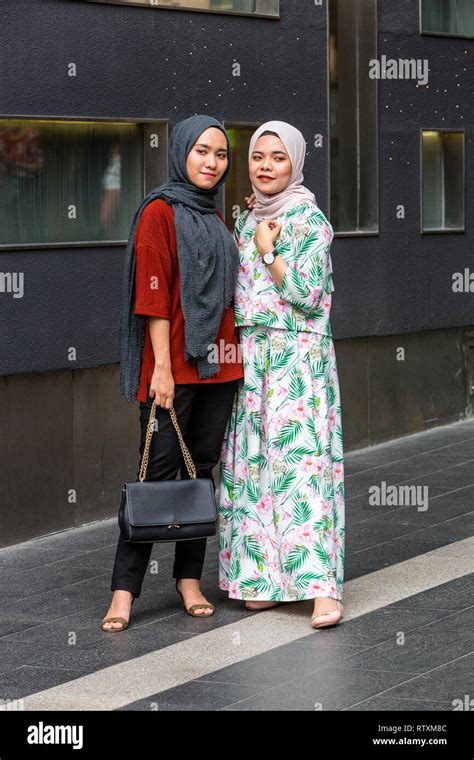 Young Malaysian Women Posing for a Photo, Traditional Dress vs. Casual Western Style, Pavilion ...