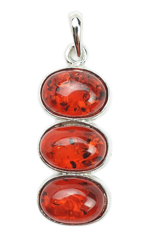 Royalty-Free photo: Silver-colored three red gemstone pendant | PickPik
