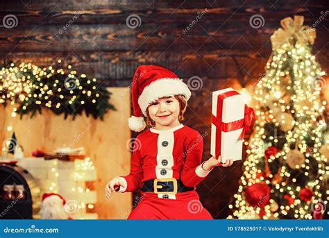 Happy Cute Child in Santa Hat with Present Have a Christmas. Christmas Kids. Christmas ...