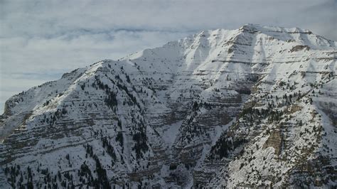 5.5K stock footage aerial video orbit snowy, rugged slopes of Mount Timpanogos in winter, Utah ...