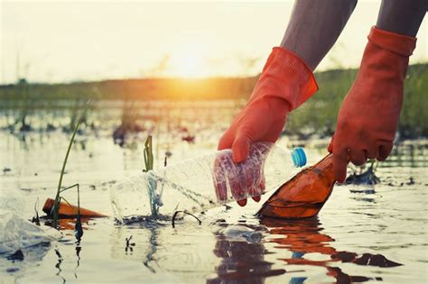 Premium Photo | Woman hand picking up garbage plastic for cleaning at ...