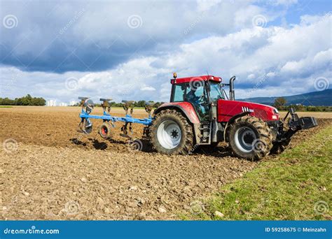 Tractor plowing a field stock image. Image of farmer - 59258675