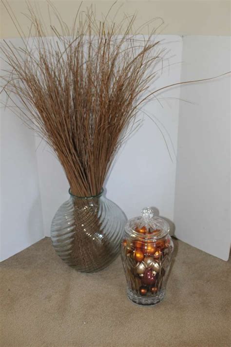 Lot #14 - Large Round Glass Vase with Grass and Glass Jar with Lid Full of Ornaments for Decor ...
