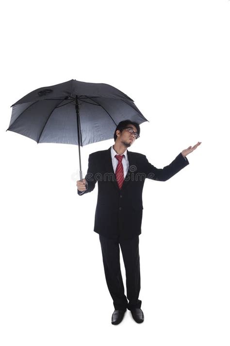 Businessman Holding Umbrella with Hand Held Out Stock Photo - Image of ...