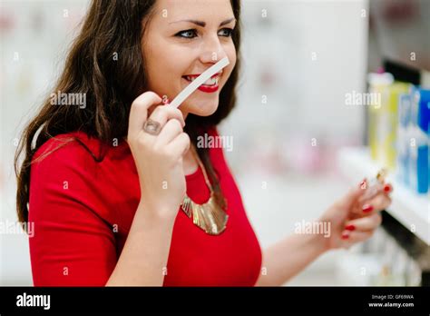 Happy woman testing new fragrances Stock Photo - Alamy