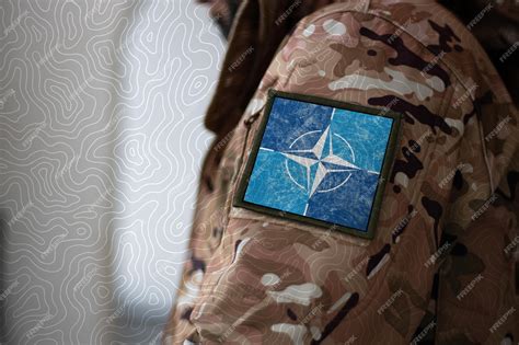 Premium Photo | Nato soldier soldier with flag nato nato flag on a ...