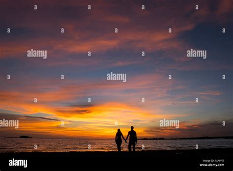 silhouette couple in the beach against sunset - Bintan island ...