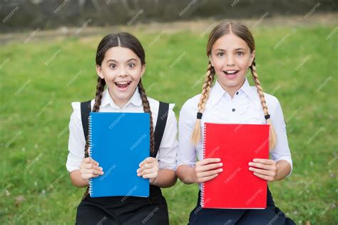 Premium Photo | Happy kids in school uniforms show colorful schoolbooks covers outdoors books