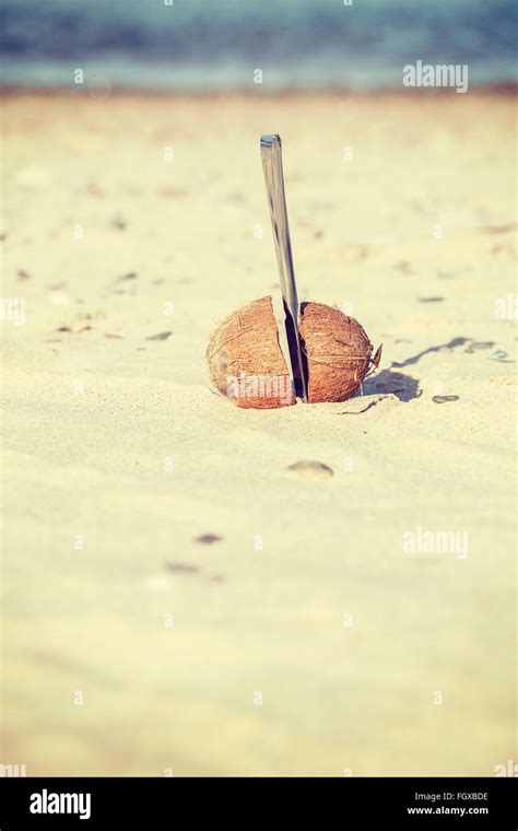 Vintage toned coconut cut in half with knife on a beach Stock Photo - Alamy