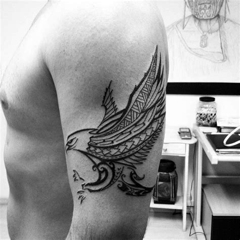 Dark black and white flying eagle tattoo on shoulder in tribal style - Tattooimages.biz