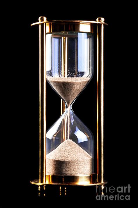 Hourglass sand timer on black Photograph by Richard Thomas - Pixels