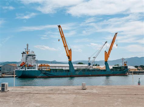 Premium Photo | Cargo ship with cranes on loading in the port