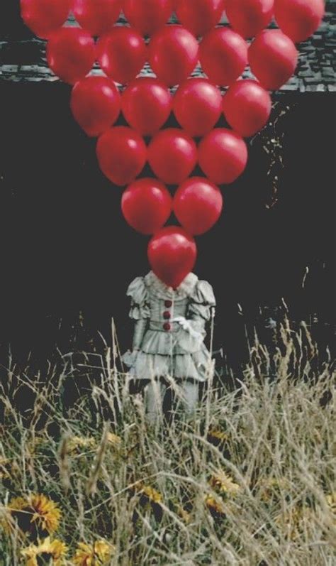 a bunch of red balloons floating in the air over a person's head and body