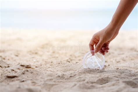 A Hand Picking Up a Plastic Glass Trash on the Beach Stock Image - Image of grab, pollution ...