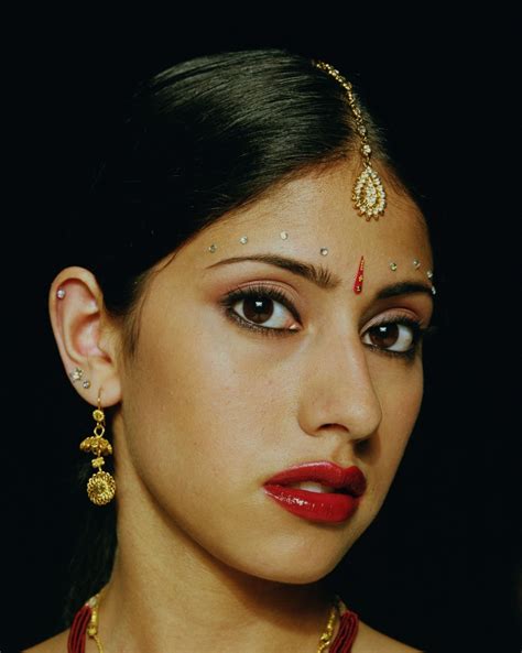 A bindi is a forehead decoration Indians wear. The red dots and the jewels they wear on their ...