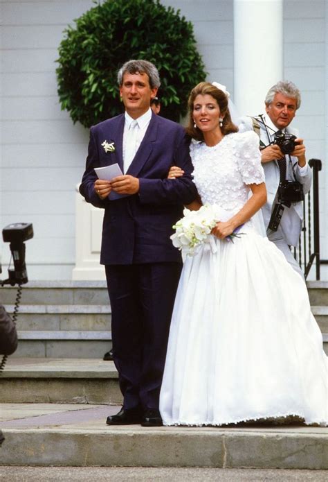 the bride and groom are standing on the steps