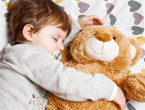 Child sleeping with teddy bear Stock Photo by ©lsantilli 127983932