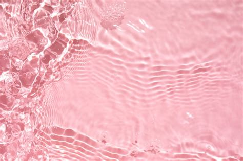 Premium Photo | Pink liquid colored clear water surface texture with splashes bubbles