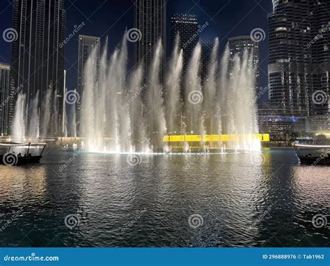 Ground View of Partial Downtown Dubai with Lighted Water Fountain at ...