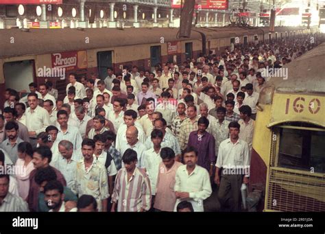 People and trains inside of the Mumbai Railway Station or Chhatrapati ...