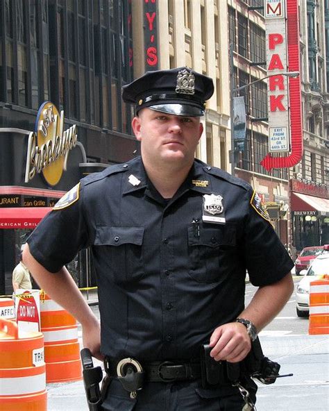 NYPD officer in Times Square after helping tourists with directions. New York, NY / July 3, 2009 ...