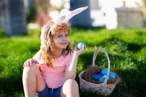 Premium Photo | Easter bunny child boy with cute face kids hunting easter eggs