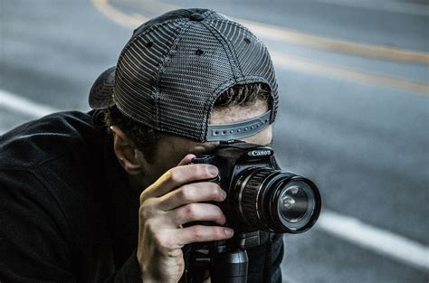 Man Taking Photo Using Black Canon DSLR Camera · Free Stock Photo