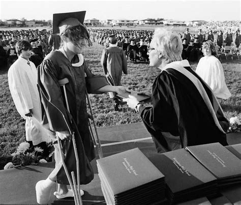 A graduate gets their diploma during the 1981 Schaumburg High School graduation. Daily Herald ...