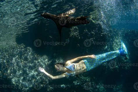 Mermaid swimming underwater in the deep blue sea 20347087 Stock Photo ...