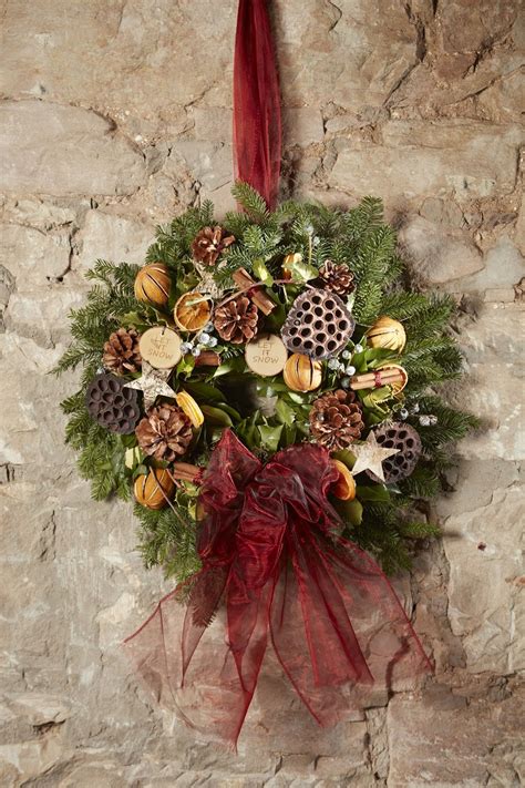 Fragrant festive wreath with dried fruit and cinnamon, plus lotus heads ...