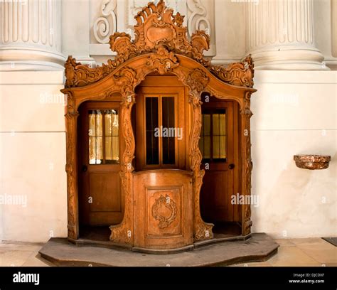 Ancient wooden carved confessional booth in Theatine Church, Munich ...