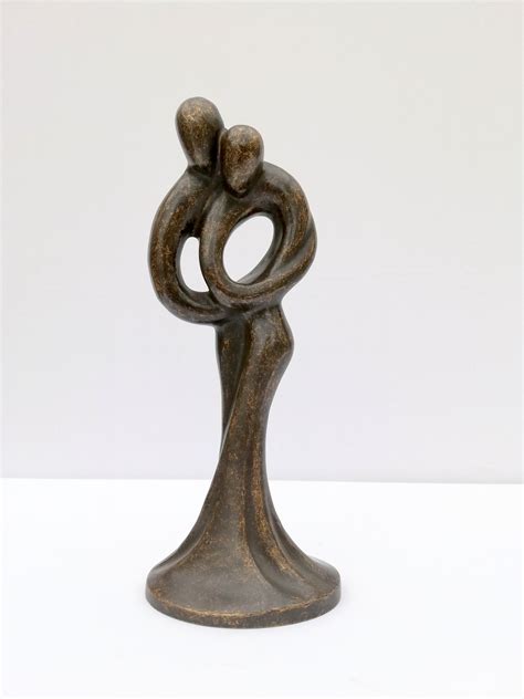 A bronze sculpture of a loving couple