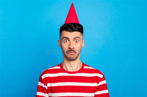 Photo of Shocked Astonished Young Man Worried Birthday Day Wear Cone Isolated on Pastel Blue ...