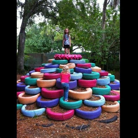 Old tires repurposed as playground equipment. This is the coolest king of the mountain idea ever ...