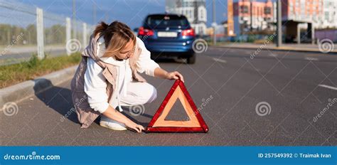 A Woman Driver Puts an Emergency Stop Sign Near a Broken Car, Traffic Accident Concept Stock ...